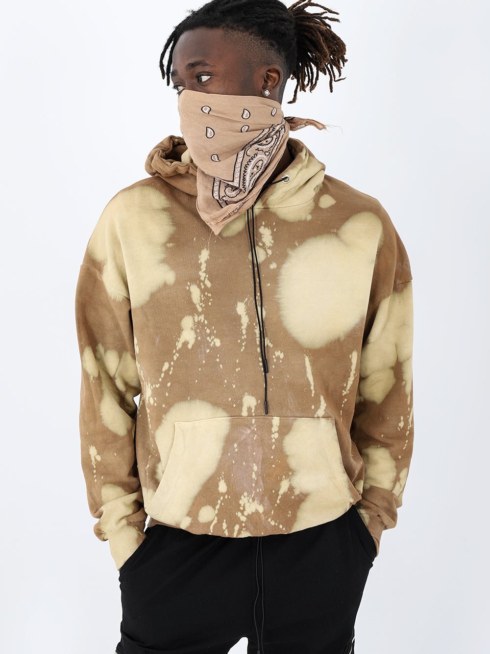 A man wearing a Burlywood tie dye hoodie and a bandana.