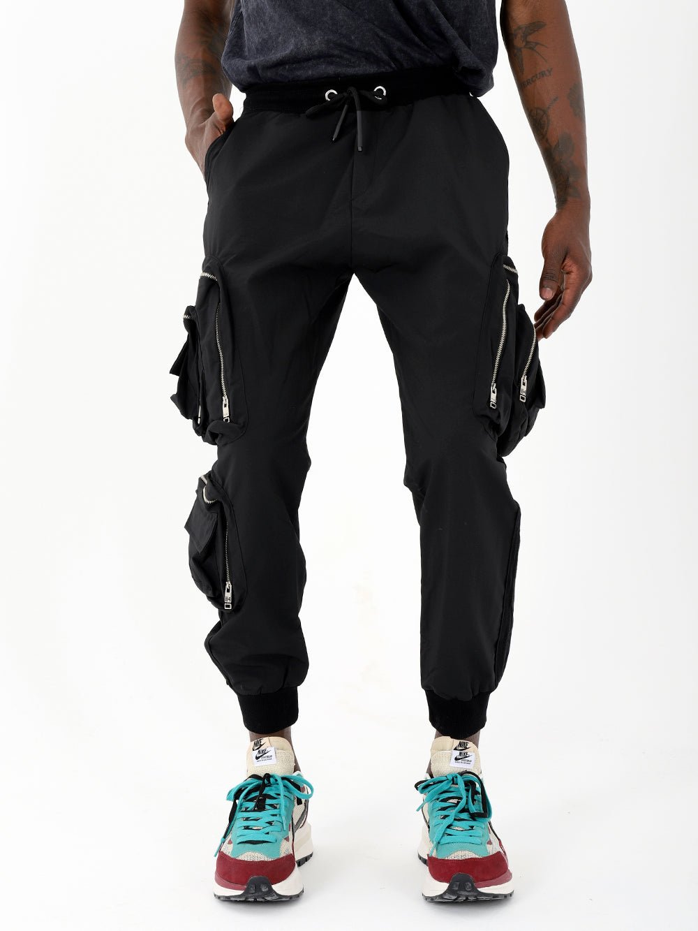 A man wearing black LAVANO joggers and sneakers.