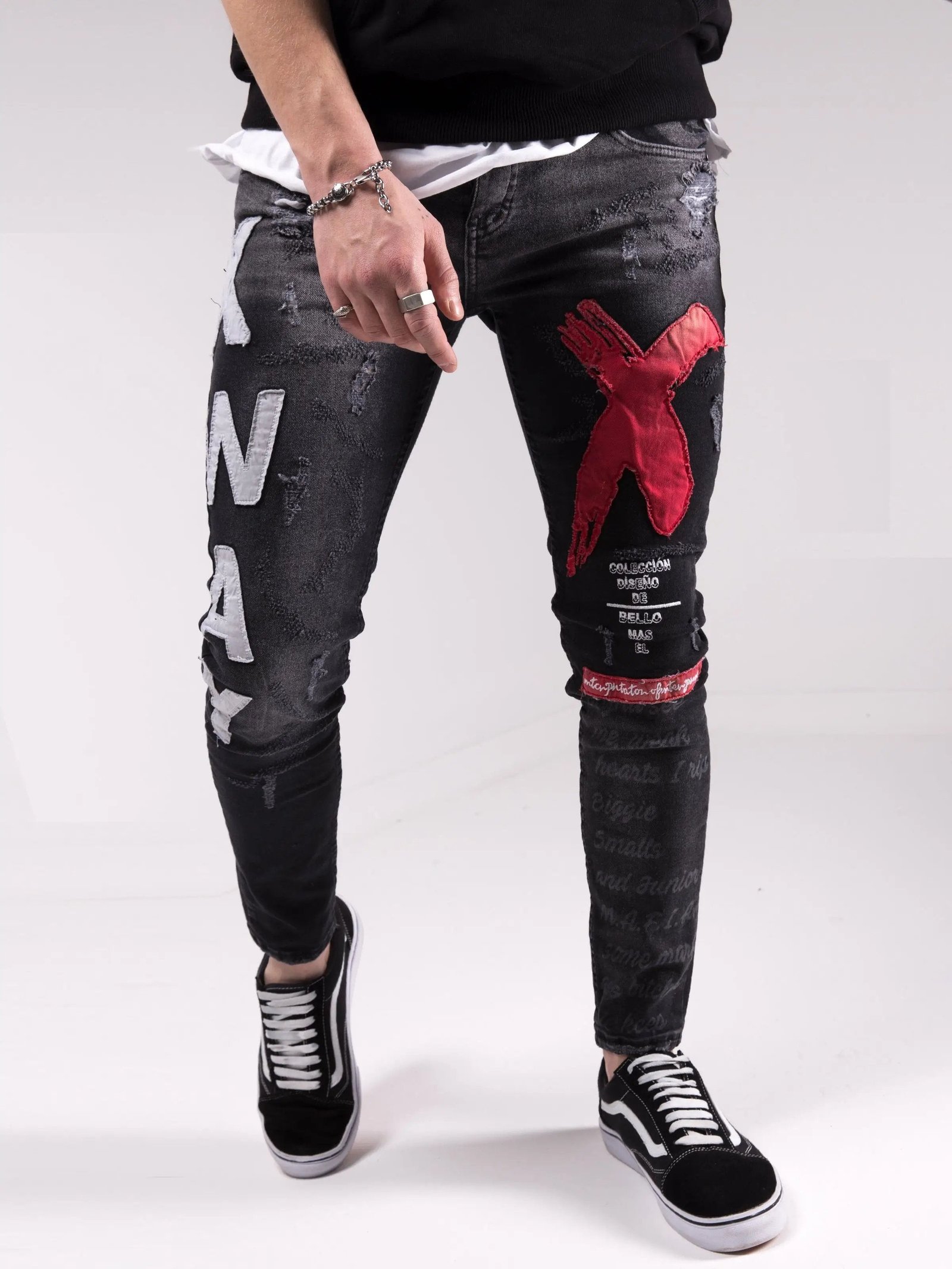 A man wearing a pair of MAD DOG skinny fit black jeans.