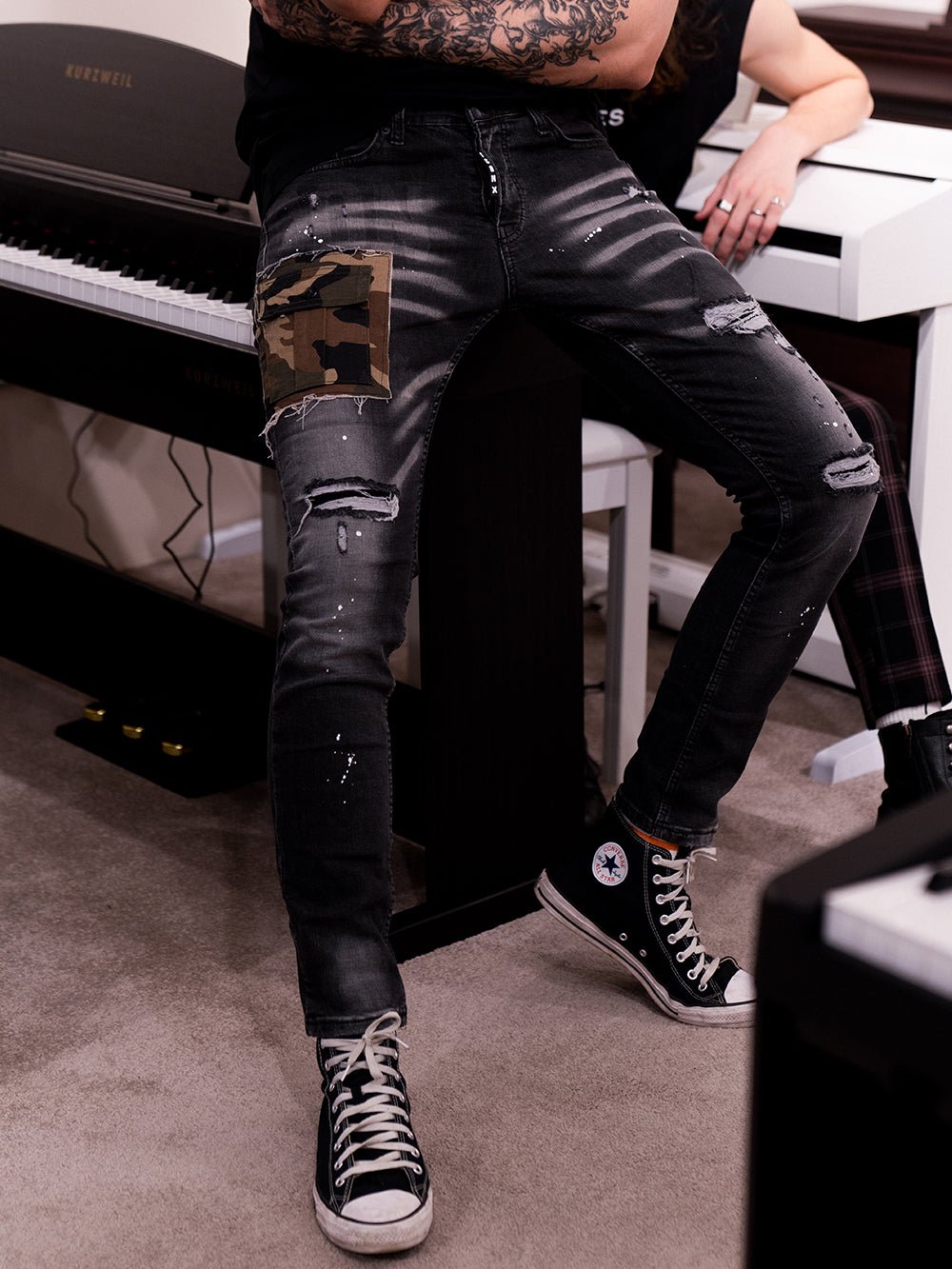A man sitting on a CAMOUFLAGE | BLACK.